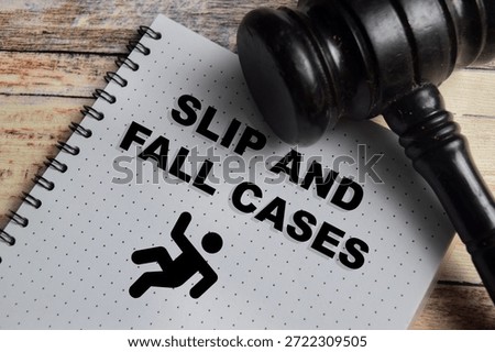 Concept of slip and fall cases write on book isolated on Wooden Table.