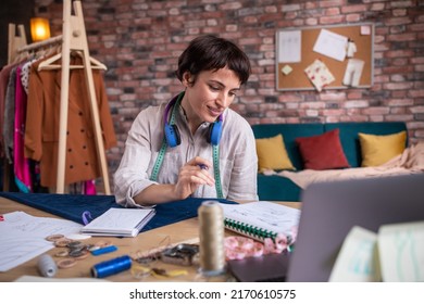 Concept Of Small Business Atelier Design Fashion Pretty Female Clothing Designer Listening Music And Enjoy The Moment She Working At Her New Collection Of Clothes.