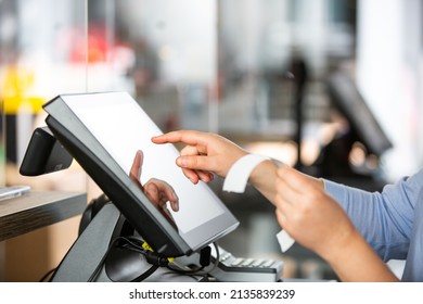Concept of small business or sevice, woman or saleswoman in apron at counter with cashbox working at clothes shop, touchscreen POS, finance concept, business