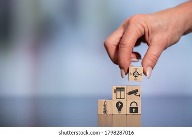 Concept of smart home with icons on wooden cubes - Shutterstock ID 1798287016