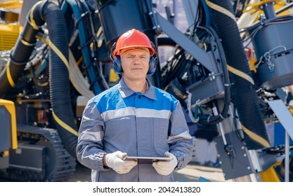 Concept smart online Industry. Offshore worker inspect with tablet drilling rig for exploration of minerals for oil, gas and artisan water.