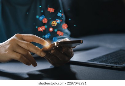 Concept of social media communication and digital online, people use smartphone playing with icon online social media, online marketing, technology, chat, post, like, follow at phone screen - Shutterstock ID 2287042921