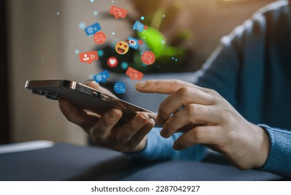 Concept of social media communication and digital online, people use smartphone playing with icon online social media, online marketing, technology, chat, post, like, follow at phone screen - Shutterstock ID 2287042927