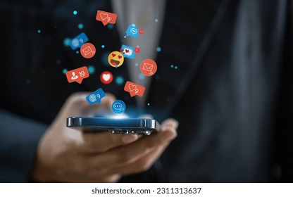 Concept of social media communication and digital online, people use smartphone playing with icon online social media, online marketing, technology, chat, post, like, follow at phone screen - Shutterstock ID 2311313637