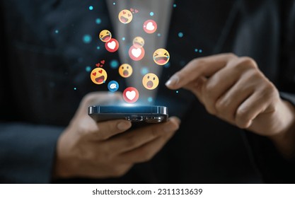 Concept of social media communication and digital online, people use smartphone playing with icon online social media, online marketing, technology, chat, post, like, follow at phone screen - Shutterstock ID 2311313639
