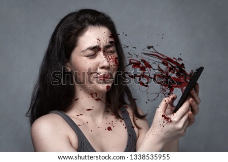 The concept of social problems, spam, support, suicide, dangerous driving . The young girl blinked in sudden fright, the phone in her hands splatters with blood.