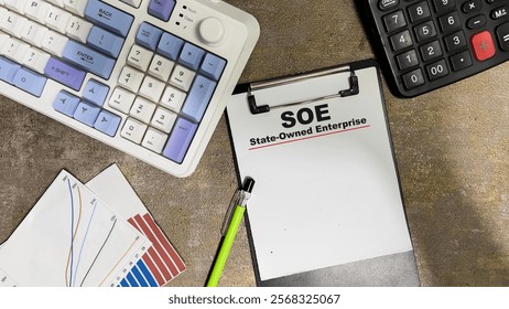 Concept of SOE - State-Owned Enterprise write on paperwork isolated on Wooden Table.