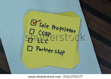 Concept of Sole Proprietor write on sticky notes isolated on Wooden Table.