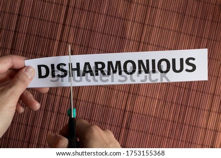 Concept solution to the problem: the word disharmony is cut with scissors to get the word harmony