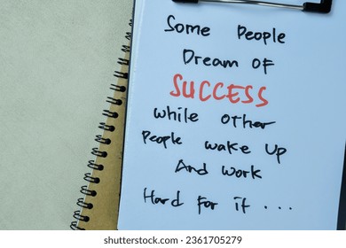 Concept of Some People Dream of Success While Other People Wake Up and Work Hard For it write on paperwork isolated on Wooden Table.