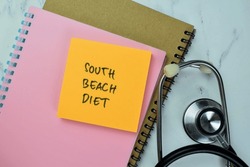 Concept Of South Beach Diet Write On Sticky Notes With Stethoscope Isolated On Wooden Table.