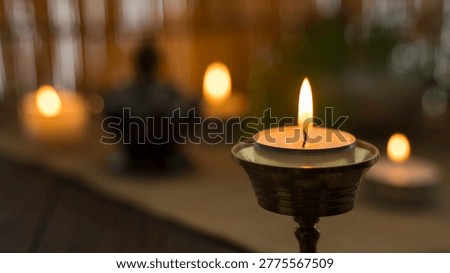 Concept of SPA . Decorative objects on the table and a candle in the foreground.