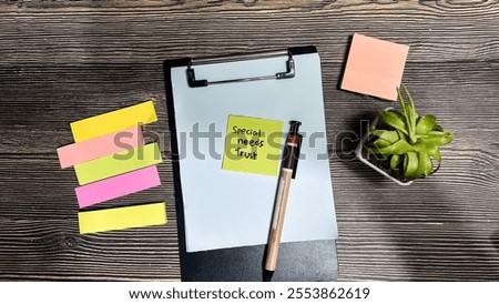 Concept of Special Needs Trust write on sticky notes isolated on Wooden Table.