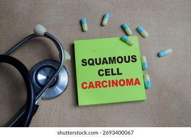Concept of squamous cell carcinoma write on sticky notes isolated on Wooden Table.