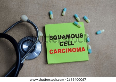 Concept of squamous cell carcinoma write on sticky notes isolated on Wooden Table.