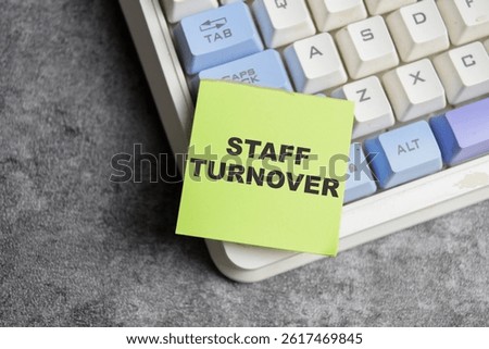Concept of Staff turnover write on sticky notes isolated on Wooden Table.