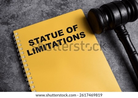 Concept of Statue of Limitations write on book isolated on Wooden Table.