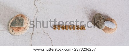 Concept stoicism word made from letters and stones on gray background top view web banner