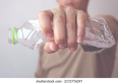 The Concept Of Stop Plastic, Recycling. Man Hand Holding A Crumpled Plastic Bottle. Vintage Style