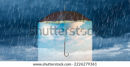 Concept of storm and heavy rain with a vintage umbrella revealing a blue sky with shining sun