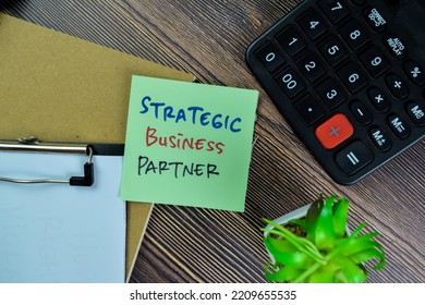 Concept Of Strategic Business Partner Write On Sticky Notes Isolated On Wooden Table.