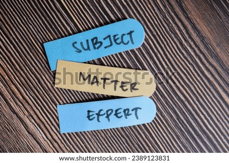 Concept of Subject Matter Expert write on sticky notes isolated on Wooden Table.