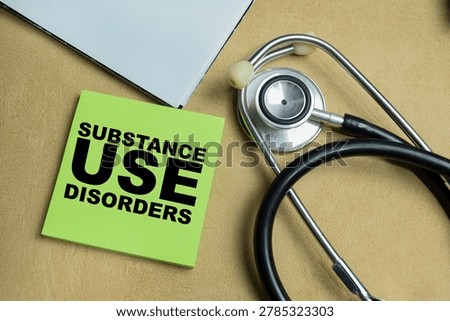 Concept of substance use disorders write on sticky notes isolated on Wooden Table.