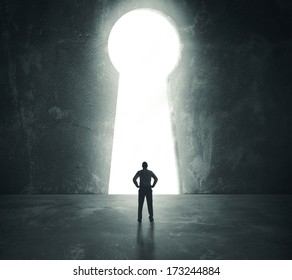 Concept of success with businessman looking through key hole