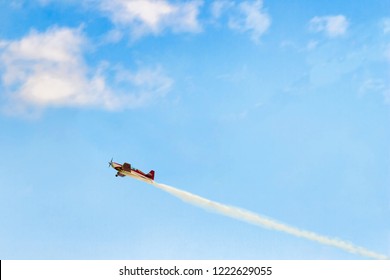Concept of success and freedom. Small red airplane rises in a blue sky. No roads, no limits.