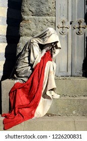 Concept of suffering and depression. Mourning, death and separation concept. Mother who cries, woman crying. Mounting statue performance with red drape. Dramatic theater art, theatrical representation