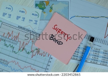 Concept of Surety Bond write on sticky notes isolated on Wooden Table.