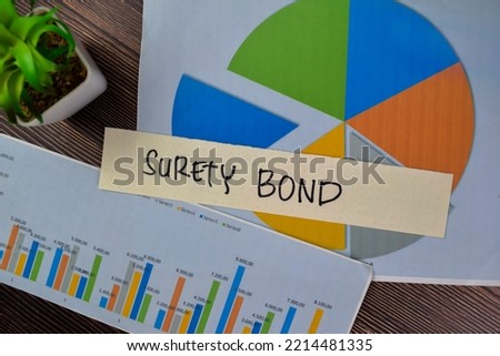 Concept of Surety Bond write on sticky notes isolated on Wooden Table.