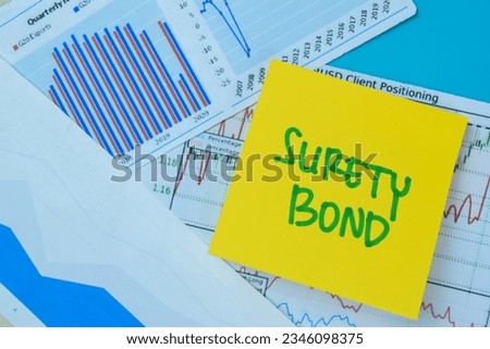 Concept of Surety Bond write on book isolated on Wooden Table.