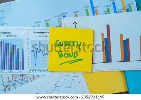 Concept of Surety Bond write on sticky notes isolated on Wooden Table.