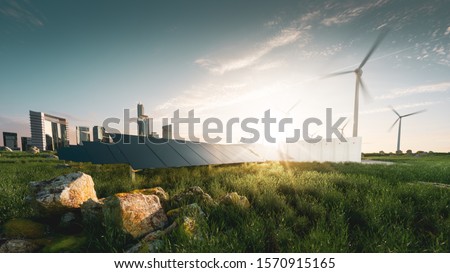 Concept of sustainable energy solution in beautifull sunset backlight. Frameless solar panels, battery energy storage facility, wind turbines and big city with skycrapers in background. 