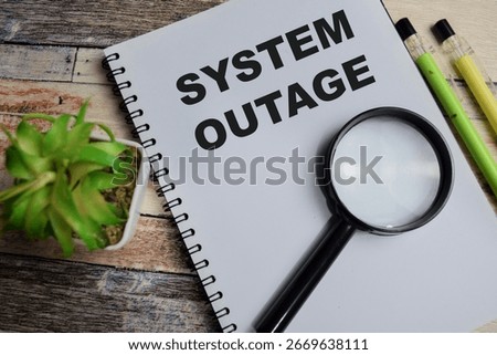 Concept of System outage write on book isolated on Wooden Table.