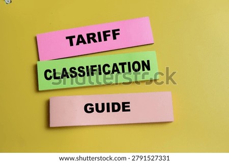 Concept of tariff classification guide write on sticky notes isolated on Wooden Table. For international trade and import-export regulations