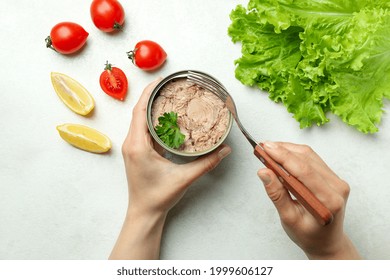 Concept Of Tasty Eating With Canned Tuna On White Textured Background