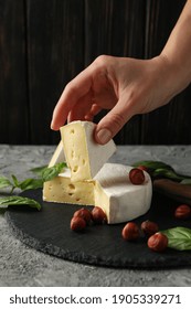 Concept Of Tasty Eating With Female Hand Hold Camembert Cheese