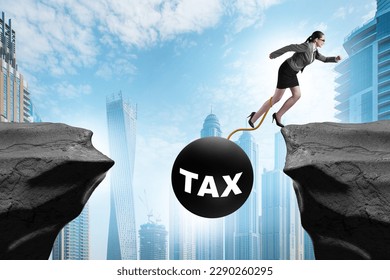 Concept of tax burden with businesswoman over chasm - Shutterstock ID 2290260295