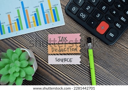 Concept of Tax Deduction Source write on sticky notes isolated on Wooden Table.