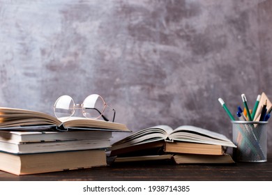 Concept to teacher's day. Pens, apple, pencils, books and glasses on table. Back to school, copy space. - Powered by Shutterstock