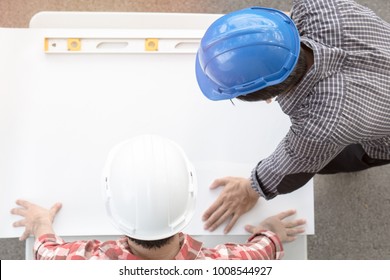 Concept Teamwork Of Building Construction Staff. Project Engineer / Contractor Reviewing Plan Of Work With Foreman And Worker At Construction Site.