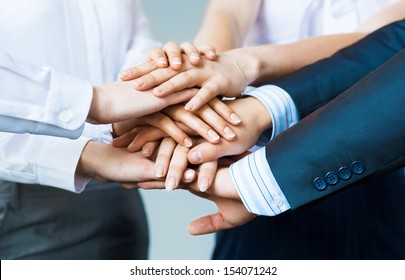 Concept Of Teamwork. Business People Joined Hands