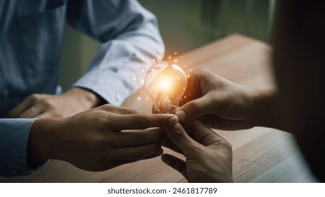 Concept of teamwork, teamwork of business people working together to grow business, group of businessholding light bulbs with brain icon, developing personnel in organization with new ideas - Powered by Shutterstock