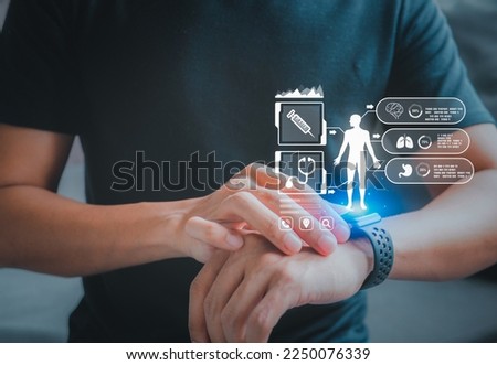 Concept of The technology to check health with smart watch. Futuristic smart watch technology male looking at watch checking health. holographic icon user interface.