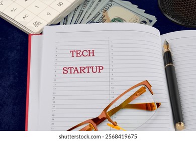 The concept of technology . The conceptual text of TECH STARTUP written in a business notebook, a conceptual photo.
