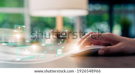 Concept technology internet and networking, hand using mouse and show digital media icon with display on table.