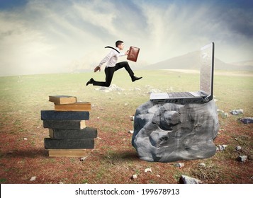 Concept Of Technology Migration With Businessman Jumping From Book To Laptop