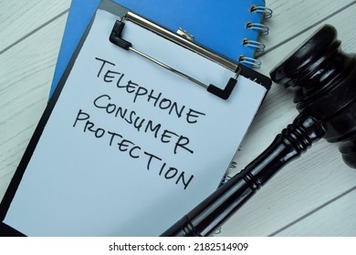 Concept Of Telephone Consumer Protection Write On A Paperwork With Gavel Isolated On Wooden Table.